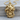 Coiled Snake Skull Pendant, gold vermeil, product photo on wood