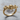 Wire mechanical skull ring, gold vermeil, three-quarter view on wood