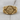 Profile Lion Shield Ring, gold vermeil, product photo on wood surface