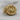 Winged Scarab Eye of Horus Ring, gold vermeil, front view on wood