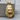 Snarling Gorilla Pendant in gold vermeil, angled front view on wood block