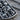 Skull wall dog tag pendant, oxidized silver, angled close-up view of skull relief