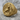 Mermaid Skull Signet Ring, gold vermeil, angled view on rock