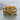 Intertwined Skull Ring, gold vermeil, front view on wet stone surface