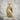 Perched Raven Pendant, gold vermeil, angled product photo on stone