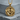 Twin Horses Pendant, gold vermeil, front view on concrete block
