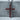Ruby cross pendant, oxidized silver, front product view on stone pedestal