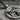 Bench Press Pendant, oxidized, angled close-up of lifter and barbell relief