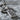 Iona Bossed Celtic Cross Pendant, oxidized silver, close-up of bosses and vine scroll
