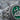 Allah Enamel Relief Ring, oxidized finish, close-up of green enamel face and leaf shoulders