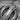 Khanda Sculpted Blade Pendant, oxidized silver, close-up of engraved blade and chakkar detail