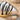 Stepped Rib Ring, close-up of fluted ribs on sand