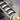Sun Medallion Tie Clip Accessory, oxidized silver, close-up showing transverse grooves and hinge mechanism