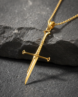 Angled view of gold plated fantasy sword necklace highlighting craftsmanship and polished surface
