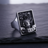 Silver Joker ring featuring gothic jester holding a skull with floating skulls on stone surface