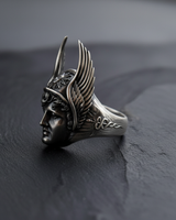 Side profile of silver Hermes ring showing the winged petasos helmet and caduceus staff carved into the oxidized silver band