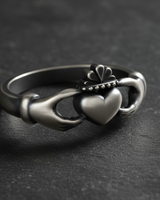 Close up of crown and heart detail on sterling silver Claddagh ring showcasing traditional Irish design texture