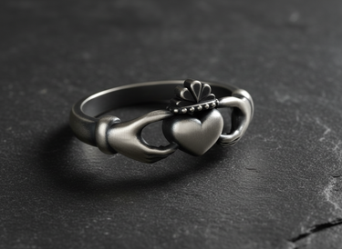 Close up of crown and heart detail on sterling silver Claddagh ring showcasing traditional Irish design texture