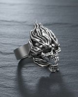 Close-up of gothic flaming skull ring made of oxidized sterling silver with detailed eye sockets