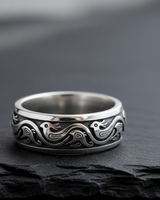 Close up detail of stylized bird motif and scrollwork on handcrafted oxidized silver ring for men and women