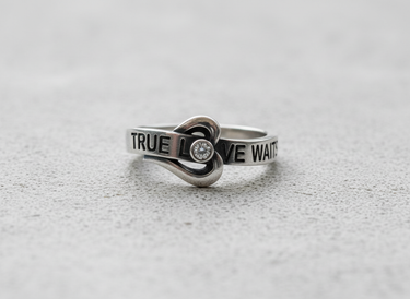 Side angle of 925 sterling silver purity ring showing engraved text true love waits and oxidized finish details