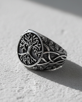 Side angle of sterling silver ring showing intricate Celtic knotwork and interwoven branches extending down the band
