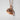 Pumpkin Leaf Pendant, rose plated silver, angled view against a white wall