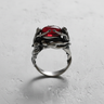 Front view of 925 sterling silver Three Graces ring holding a red gemstone on white background