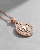 Rose gold plated silver Ophiuchus pendant featuring serpent bearer relief on textured background