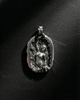 Front view of handcrafted silver sculpting woman pendant highlighting hammer and chisel details on black background