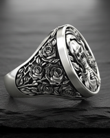 Side profile of handcrafted gothic silver ring displaying intricate rose and thorn details extending down the ring shank