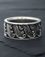 925 sterling silver ocean wave ring featuring intricate Japanese style cresting waves on a dark stone background
