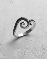 Angled view of sterling silver tentacle ring highlighting the polished band and darkened details of the sea creature design
