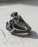 Profile view of men's sterling silver skull ring highlighting deep relief carving and premium polished metal texture