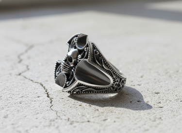 Profile view of men's sterling silver skull ring highlighting deep relief carving and premium polished metal texture