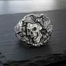 925 sterling silver eagle skull ring featuring detailed bird wings and skull profile on dark stone background