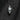 Tilted Crown Skull Pendant, front view on dark charred timber