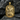 Detailed 925 sterling silver Roman soldier pendant with gold vermeil resting on textured dark gray stone