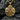 Close-up of the detailed metalwork on the masonic owl pendant resting on dark stone showing precise craftsmanship