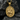 Golden Saint George pendant showcasing intricate Catholic Christian medal design resting against dark textured rock.