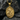 Close-up of gold vermeil Saint Andrew pendant on textured rock background highlighting craftsmanship