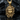 Close-up of premium gold plated Medusa pendant displaying intricate serpent details resting against a dark textured rock