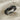 Ruby Eye Serpent Ring, black rhodium plated, angled view on linen fabric