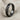 Diagonal Twist Ring, black rhodium, angled standing view on fabric