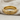 Elegant 925 sterling silver rope band ring with gold finish resting on a beautifully textured beige linen fabric