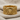 Angled view of the intricate lion band ring resting on textured fabric showing detailed side metalwork