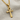 Close-up of polished Egyptian Ankh pendant resting flat on light grey textured fabric highlighting smooth curves