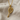 Tennis Racket Pendant, gold vermeil, product photo on textured fabric