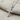Gemstone Cross Pendant in polished silver, angled close-up view