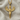 Close-up of 14k gold vermeil Goddess Isis pendant showing intricate feather details on textured fabric